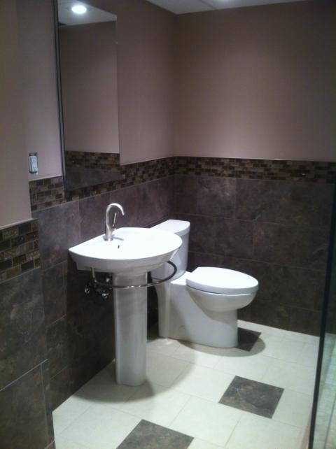 Wall Tile with mosaic wrap around into shower system, Nice Flow -the medicine cabinet is recessed into the wall as well.